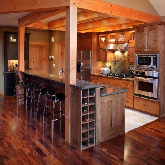 Example of a mountain style medium tone wood floor kitchen design