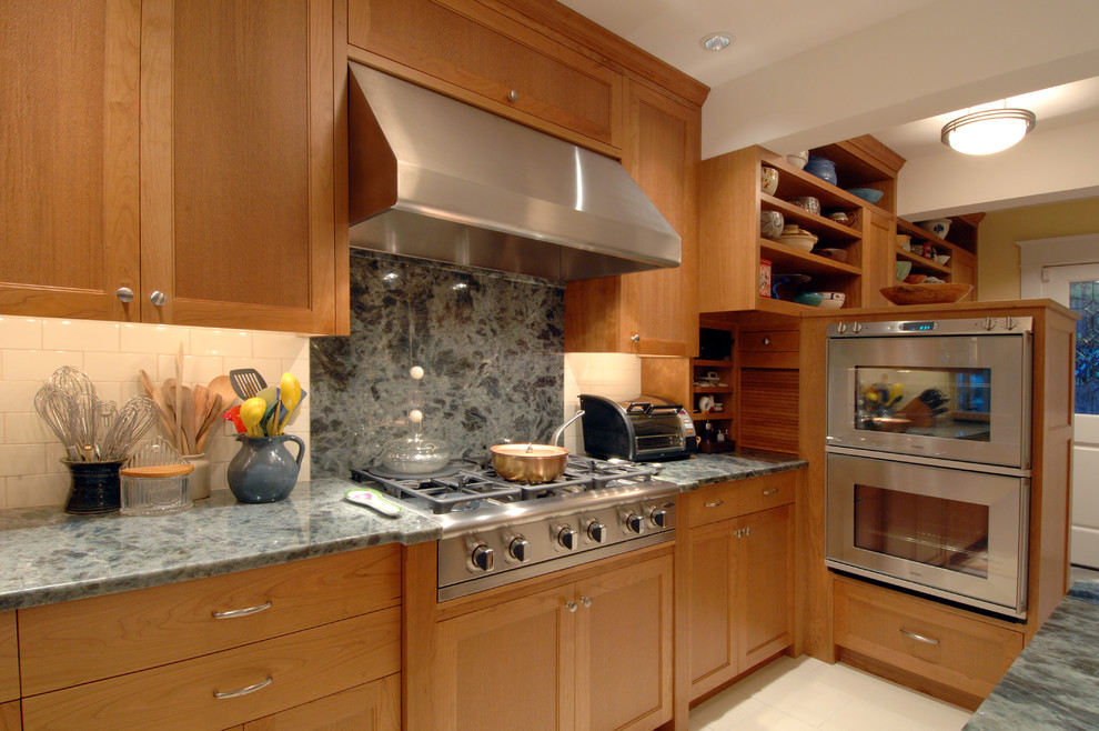 Mid-sized transitional u-shaped limestone floor eat-in kitchen photo in Seattle with a single-bowl sink, shaker cabinets, medium tone wood cabinets, onyx countertops, beige backsplash, ceramic backsplash, stainless steel appliances and two islands