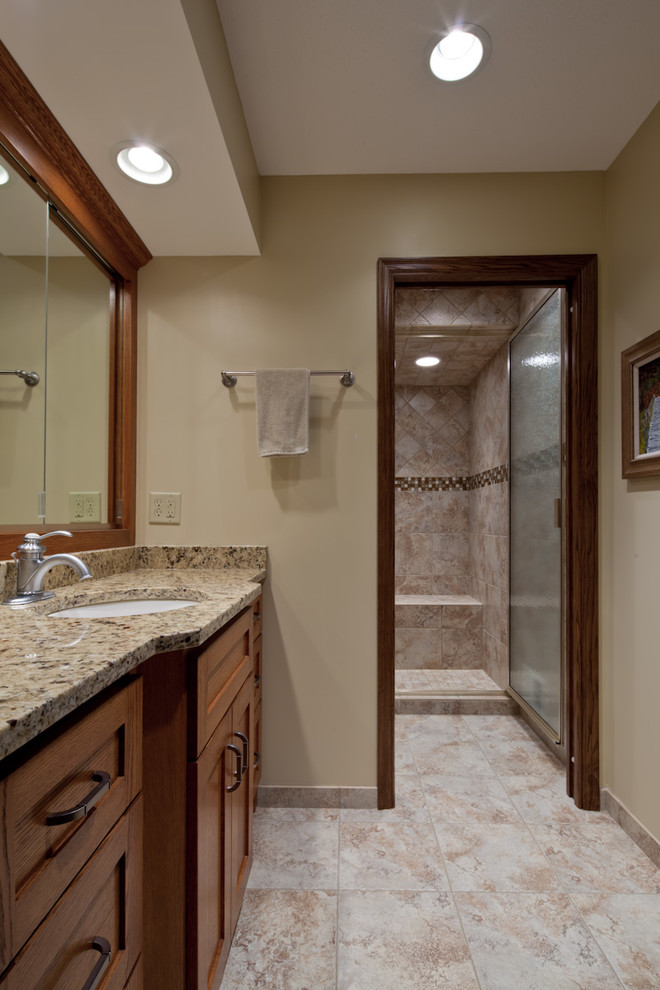 Inspiration for a large contemporary master bathroom in Minneapolis with furniture-like cabinets, dark wood cabinets, granite benchtops, blue tile and grey walls.