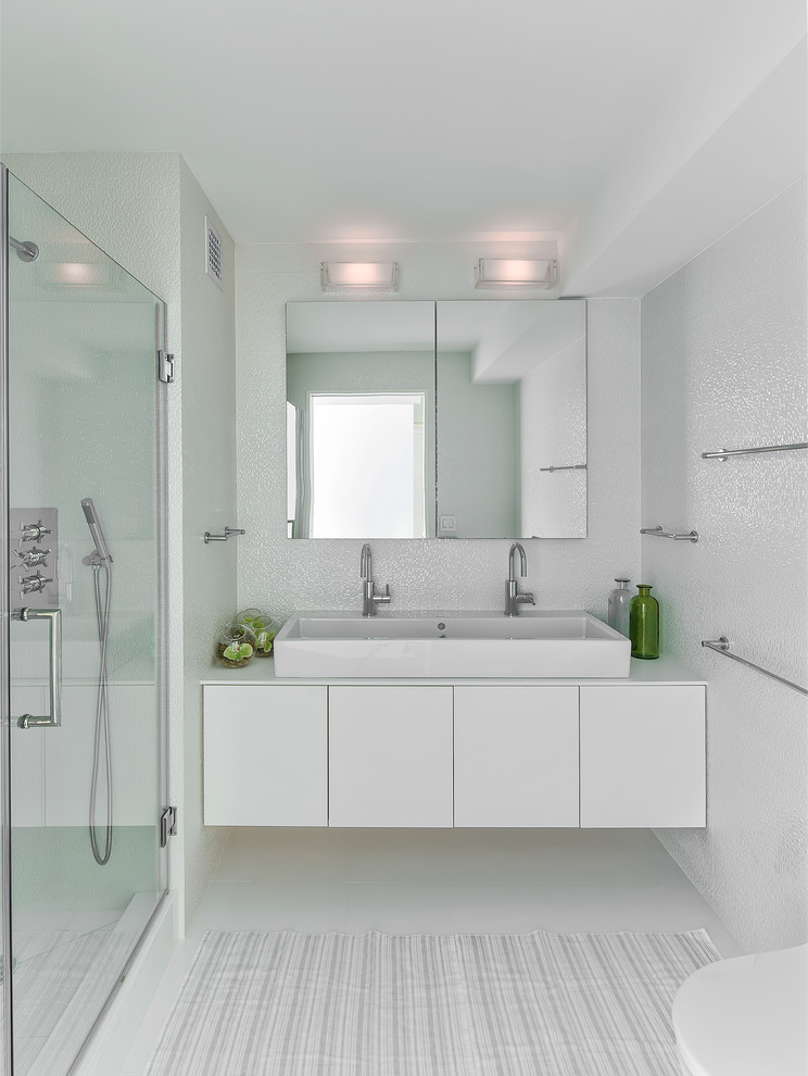 Design ideas for a small contemporary bathroom in New York with white tile, white walls and a trough sink.