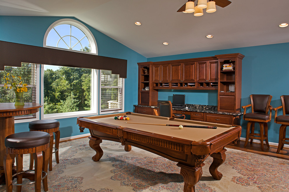 This is an example of a mid-sized traditional enclosed family room in Baltimore with a game room, blue walls and light hardwood floors.