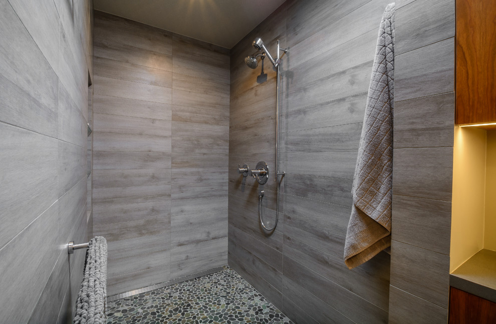 Design ideas for a mid-sized modern master bathroom in Los Angeles with flat-panel cabinets, medium wood cabinets, an open shower, gray tile, porcelain tile, grey walls, pebble tile floors, engineered quartz benchtops and an open shower.