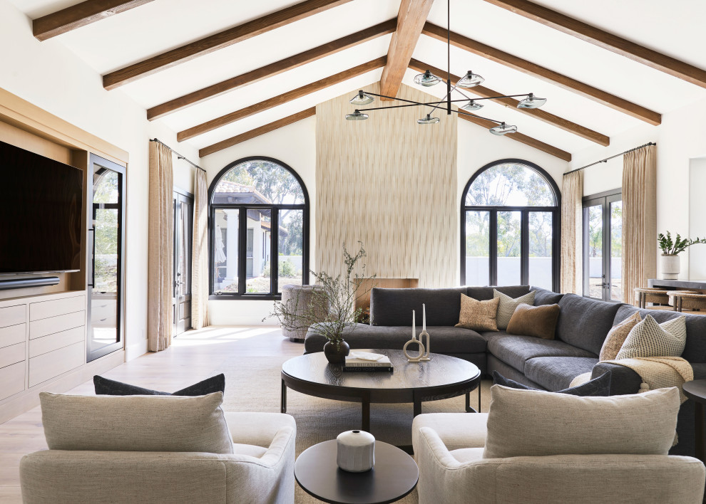 Photo of a large transitional family room in San Diego with a standard fireplace, a tile fireplace surround, a built-in media wall and exposed beam.