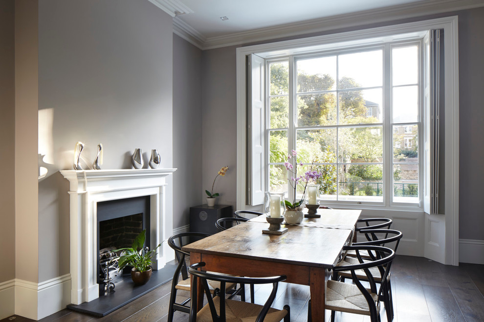 Photo of a contemporary dining room in London with dark hardwood floors.