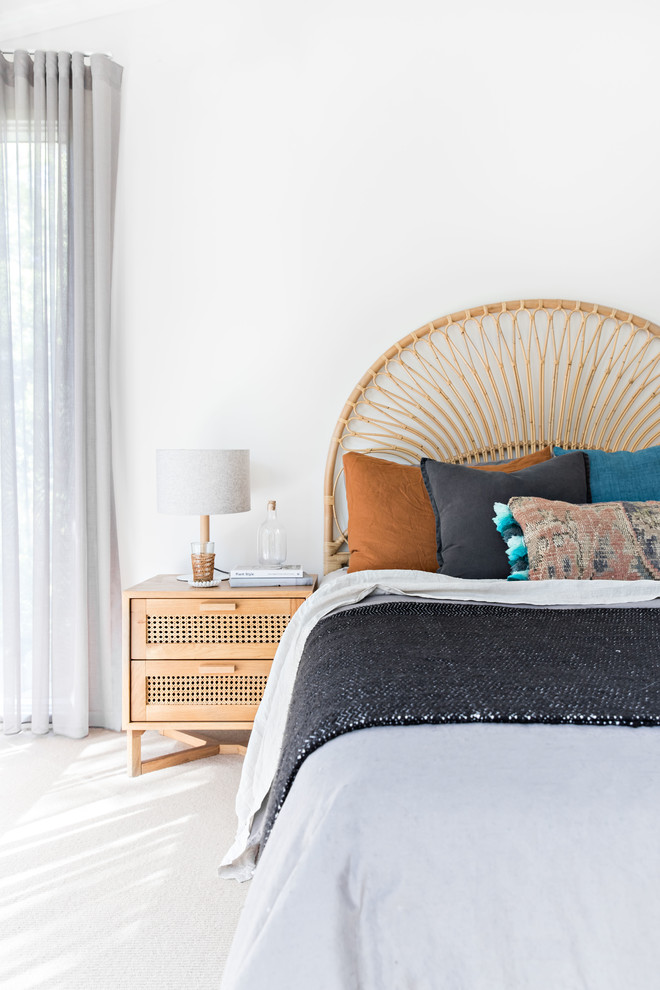 Photo of a beach style bedroom in Wollongong with white walls and white floor.