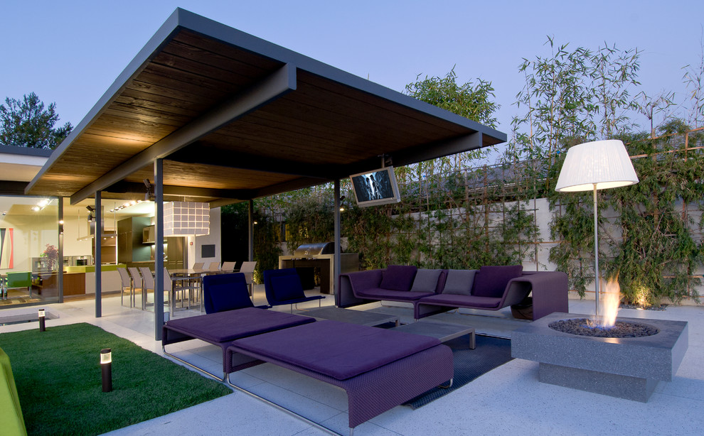 Design ideas for a large modern backyard patio in Los Angeles with a fire feature, tile and an awning.