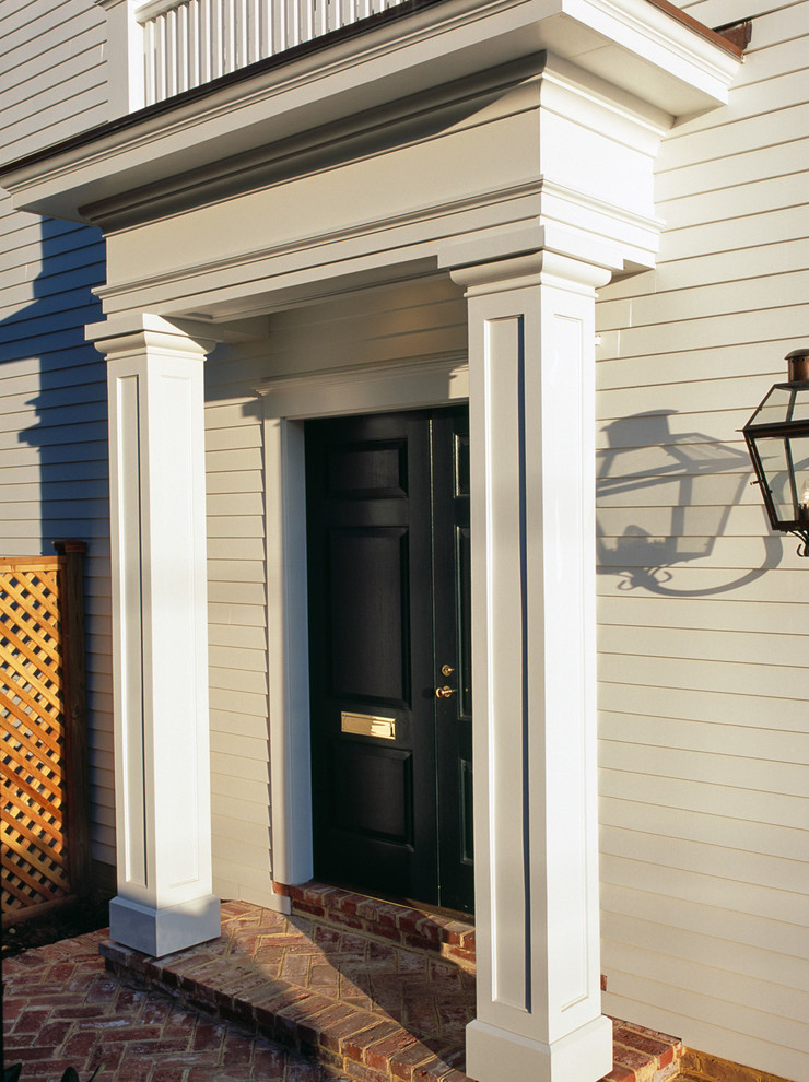 Mid-sized traditional front door in DC Metro with white walls, a double front door and a green front door.