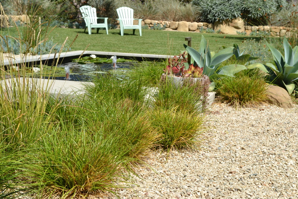 Photo of an expansive contemporary backyard full sun garden in San Luis Obispo with a water feature and gravel.