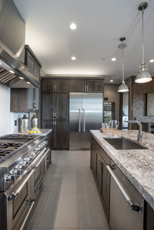 Photo of a large country eat-in kitchen in Salt Lake City with a drop-in sink, grey cabinets, granite benchtops, white splashback, ceramic splashback, stainless steel appliances, ceramic floors and with island.