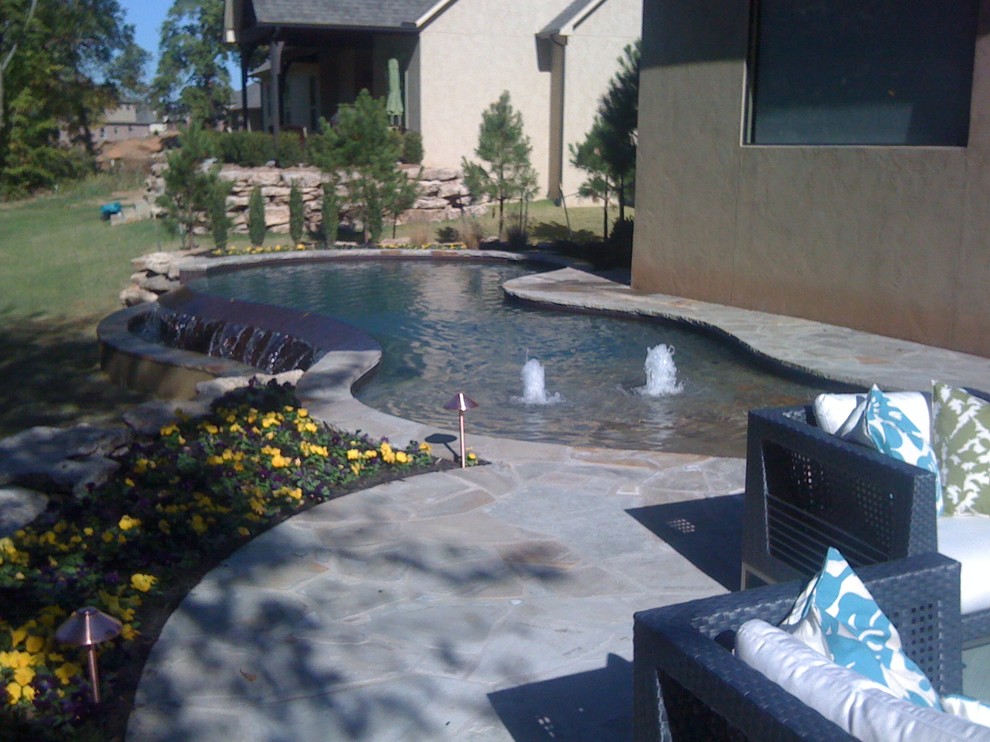 Inspiration for a backyard freeform infinity pool fountain remodel