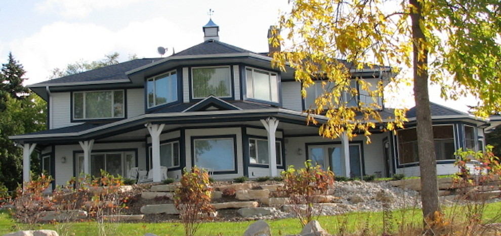 Example of a mid-sized transitional gray two-story concrete fiberboard exterior home design in Milwaukee