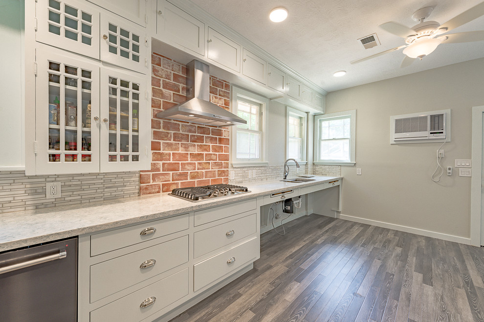 Example of a large mountain style galley dark wood floor eat-in kitchen design in Austin with a farmhouse sink, open cabinets, white cabinets, quartzite countertops, multicolored backsplash, marble backsplash, stainless steel appliances and no island