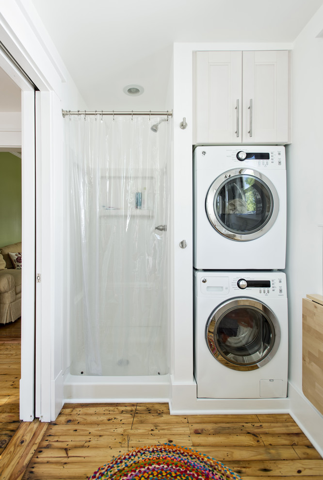 Traditional utility room in Louisville with a stacked washer and dryer.