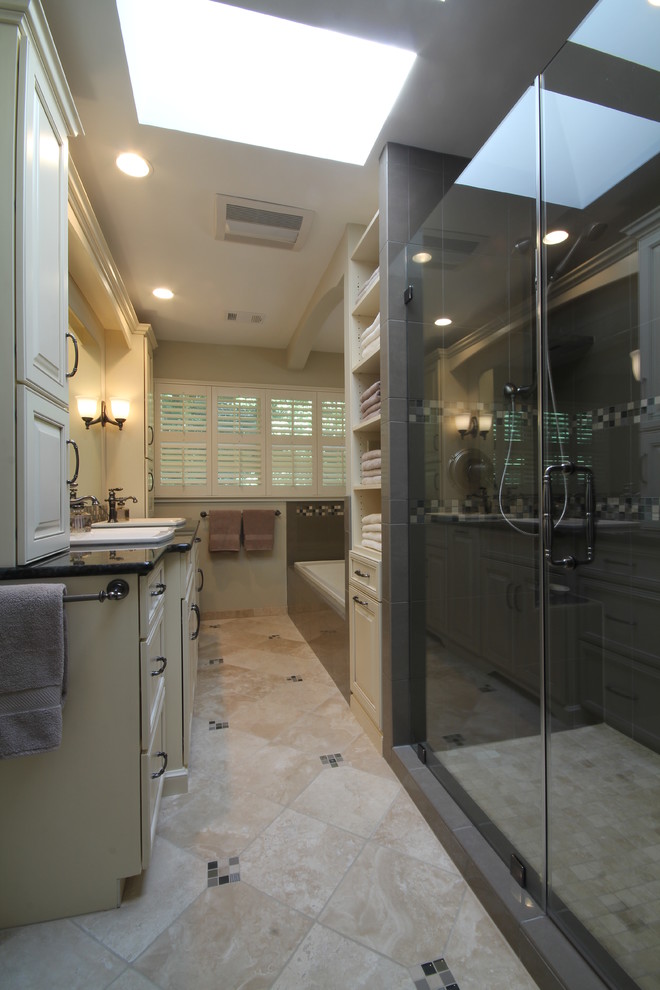 Photo of a mid-sized transitional master bathroom in DC Metro with a drop-in sink, raised-panel cabinets, white cabinets, beige tile, ceramic tile, beige walls, ceramic floors, a drop-in tub, an alcove shower and granite benchtops.