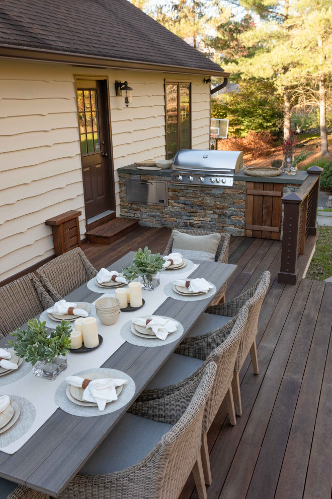 Design ideas for an expansive traditional backyard deck in Other with an outdoor kitchen and cable railing.