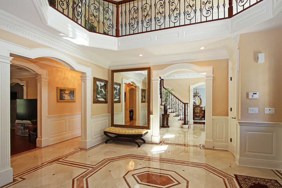 This is an example of a large traditional foyer in New York with beige walls and linoleum floors.