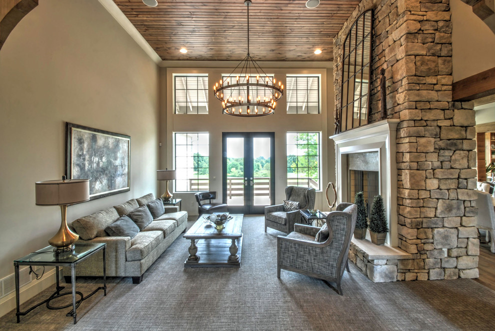 Large traditional open concept family room in Cleveland with a stone fireplace surround.