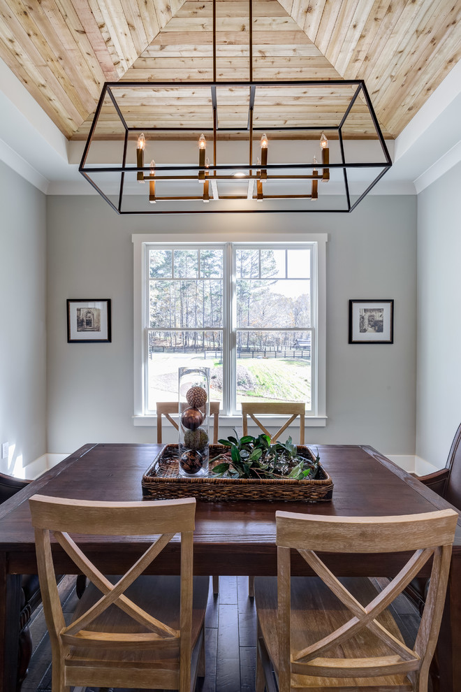 This is an example of a transitional separate dining room in Atlanta with grey walls, dark hardwood floors and no fireplace.