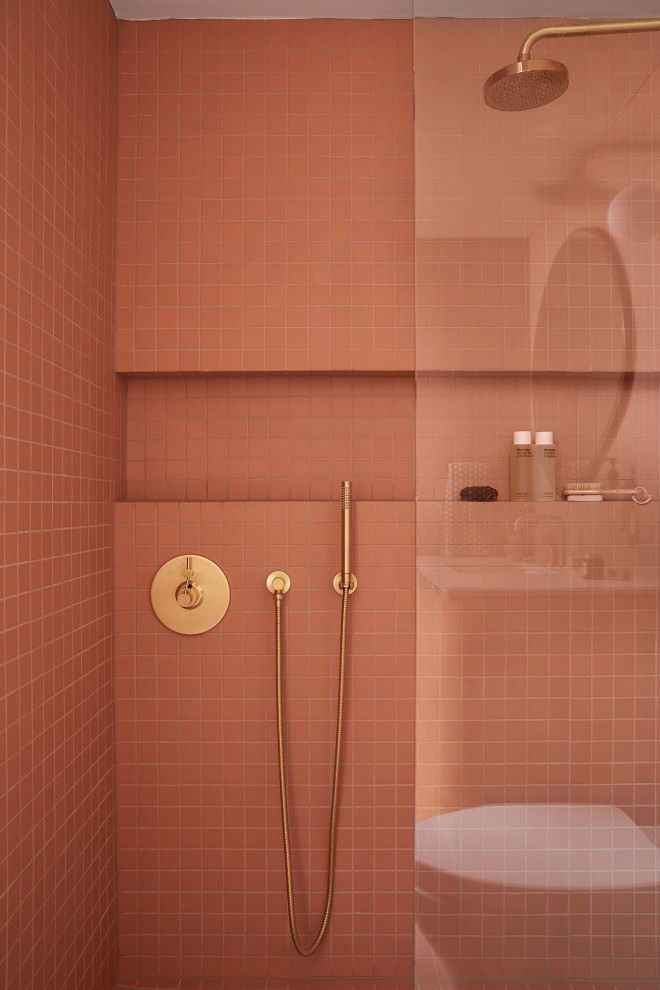 Small retro bathroom in San Francisco with light wood cabinets, a built-in shower, a one-piece toilet, pink tiles, ceramic tiles, pink walls, ceramic flooring, a submerged sink, engineered stone worktops, pink floors, a hinged door, grey worktops, a wall niche, a single sink and a floating vanity unit.