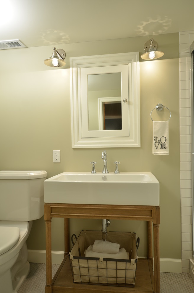 Mid-sized traditional bathroom in Portland with furniture-like cabinets, light wood cabinets, an alcove shower, a two-piece toilet, white tile, subway tile, beige walls, ceramic floors and a console sink.