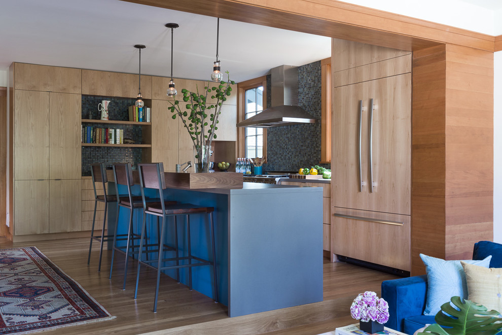 Design ideas for a mid-sized arts and crafts l-shaped open plan kitchen in San Francisco with a single-bowl sink, flat-panel cabinets, medium wood cabinets, concrete benchtops, blue splashback, ceramic splashback, stainless steel appliances, medium hardwood floors and with island.