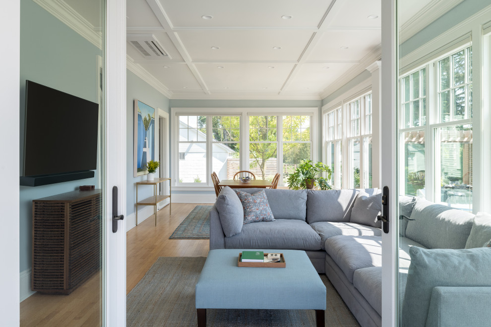 Example of a large transitional light wood floor sunroom design in Burlington with a standard ceiling