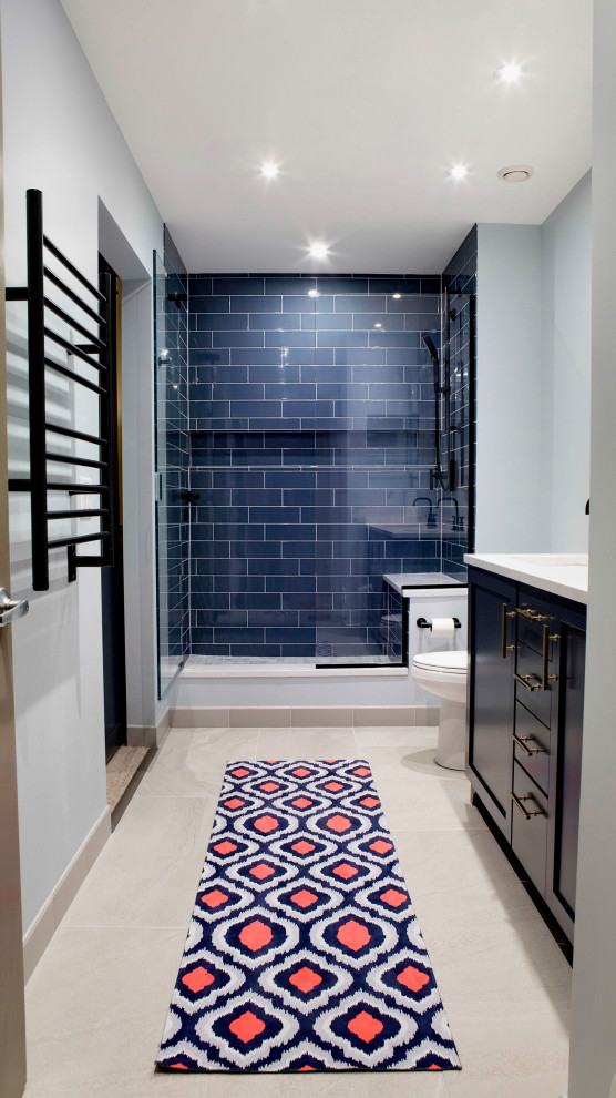 Example of a mid-sized transitional master blue tile and porcelain tile concrete floor, beige floor and double-sink doorless shower design in Chicago with raised-panel cabinets, blue cabinets, a two-piece toilet, blue walls, an undermount sink, quartzite countertops, a hinged shower door, white countertops and a built-in vanity