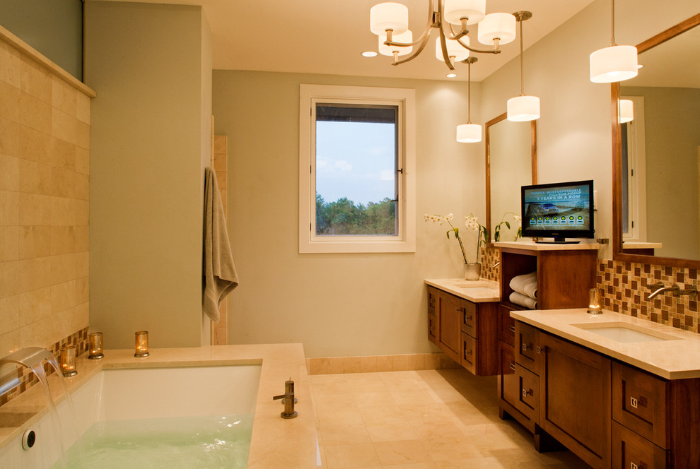 Inspiration for a large traditional master bathroom in Austin with beige walls, marble floors, an undermount sink, recessed-panel cabinets, dark wood cabinets, an undermount tub, beige tile, brown tile, mosaic tile, solid surface benchtops, a corner shower, a two-piece toilet, beige floor and a hinged shower door.