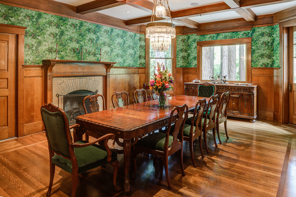 Mid-sized traditional separate dining room in San Francisco with green walls, medium hardwood floors, a standard fireplace, a brick fireplace surround and brown floor.
