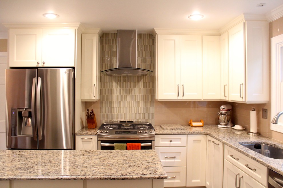 Inspiration for a mid-sized transitional u-shaped porcelain tile and brown floor eat-in kitchen remodel in DC Metro with an undermount sink, recessed-panel cabinets, white cabinets, granite countertops, beige backsplash, porcelain backsplash, stainless steel appliances and an island