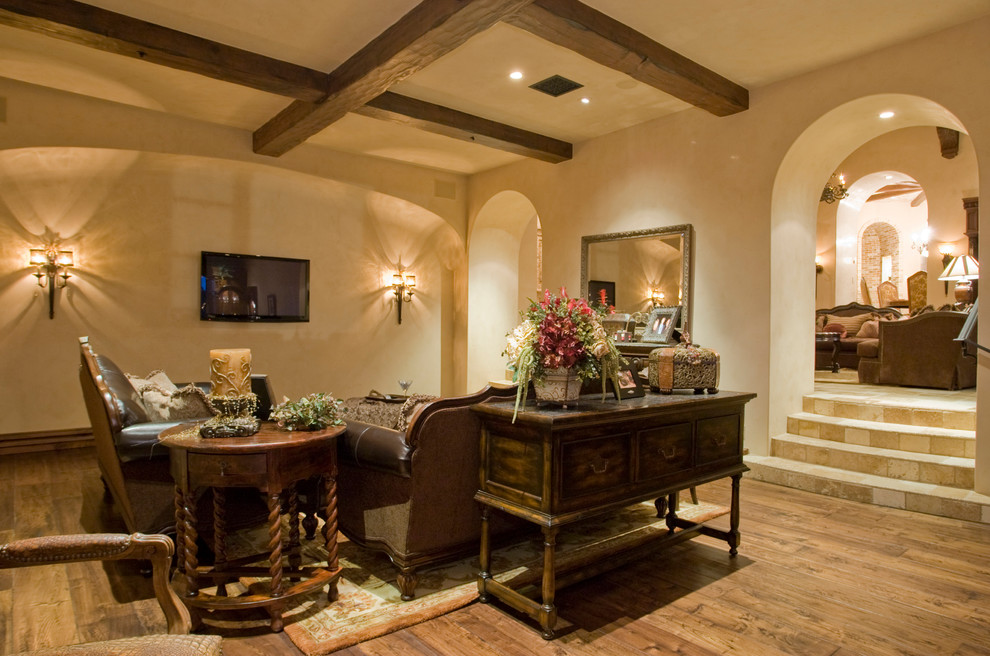 Expansive traditional formal open concept living room in Phoenix with beige walls, medium hardwood floors, a standard fireplace, a stone fireplace surround and a wall-mounted tv.