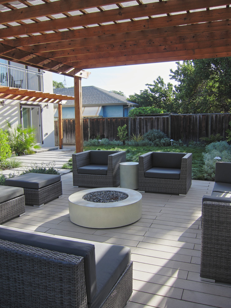 Design ideas for a mid-sized modern backyard full sun garden in San Francisco with concrete pavers and a fire feature.