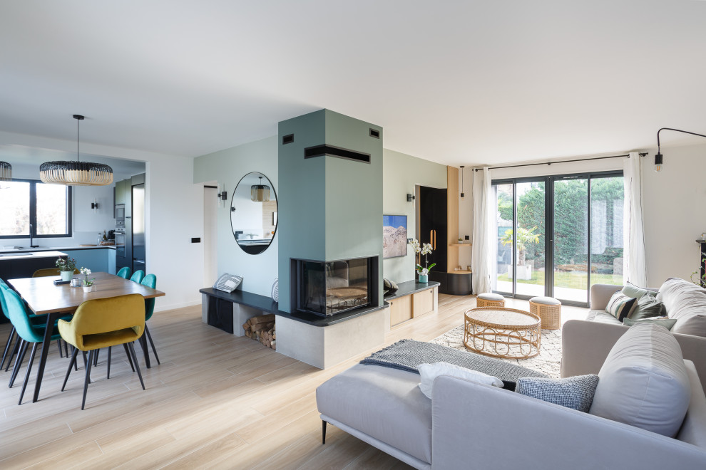 This is an example of a large scandi living room in Paris with a corner fireplace.