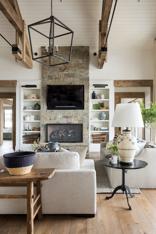 Inspiration for a large transitional open concept medium tone wood floor and brown floor family room remodel in Salt Lake City with white walls, a two-sided fireplace, a stone fireplace and a wall-mounted tv