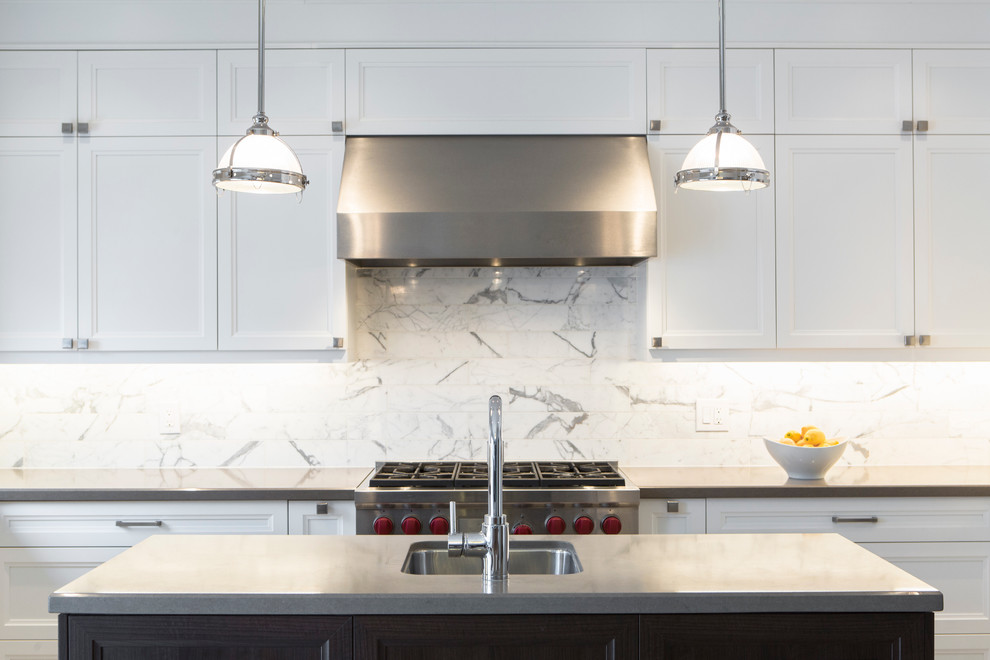 Eat-in kitchen - mid-sized transitional u-shaped porcelain tile eat-in kitchen idea in Toronto with an undermount sink, recessed-panel cabinets, white cabinets, quartz countertops, white backsplash, stone tile backsplash, stainless steel appliances and an island