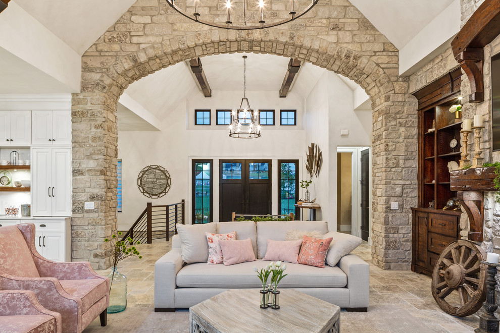 Design ideas for an expansive country formal open concept living room in Cincinnati with multi-coloured walls, travertine floors, a standard fireplace, a stone fireplace surround, a wall-mounted tv and multi-coloured floor.