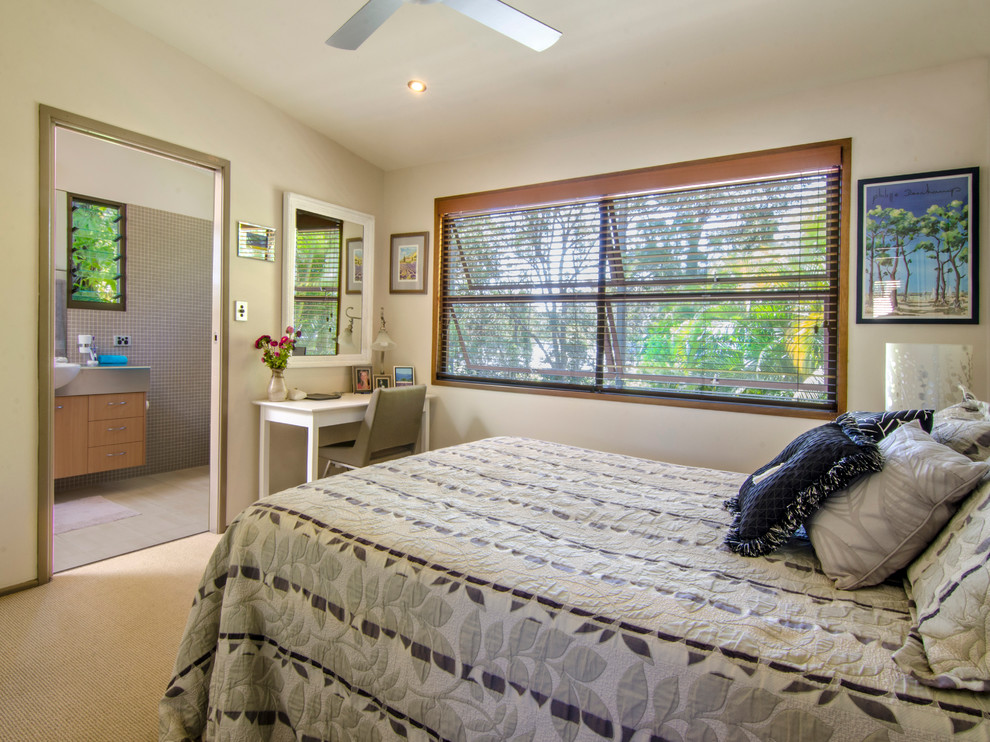 Photo of a mid-sized beach style master bedroom in Sunshine Coast with white walls and carpet.