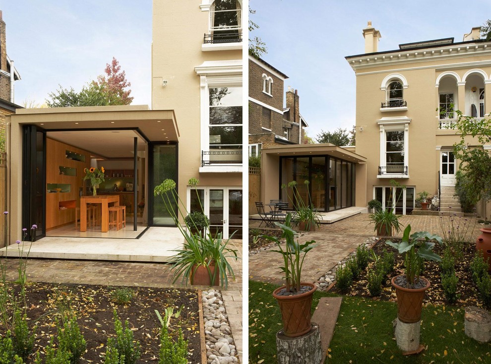 Design ideas for a mid-sized modern one-storey stucco beige exterior in London.