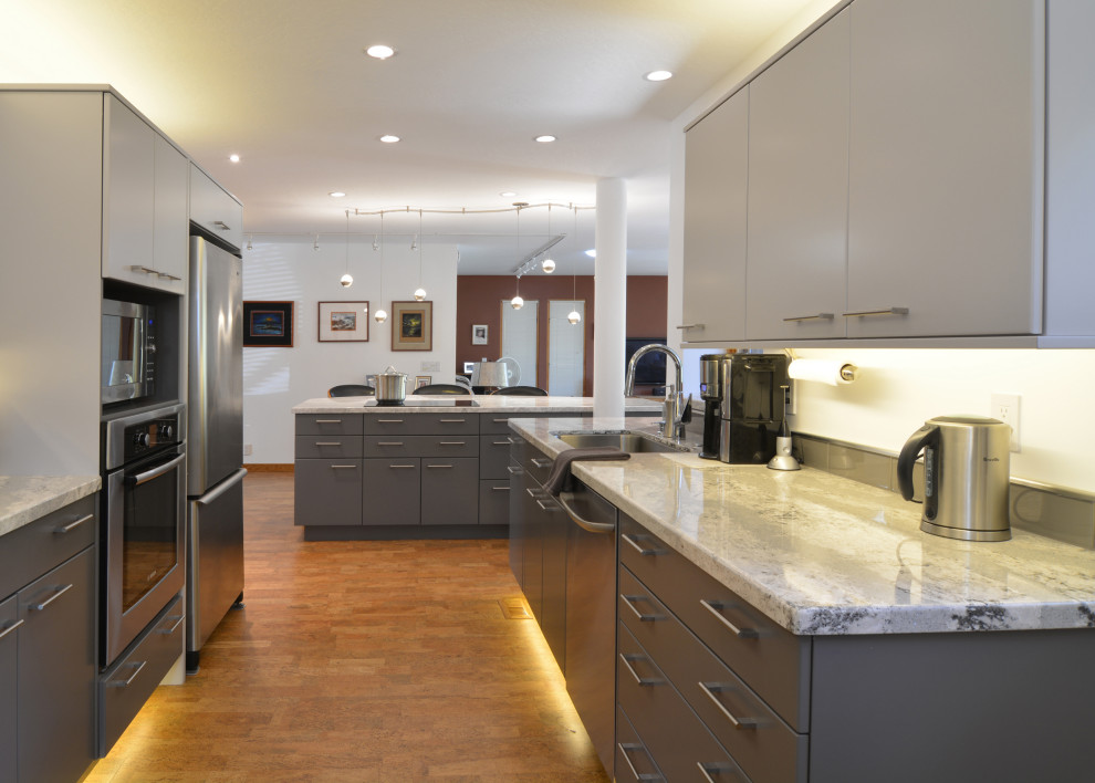 Inspiration for a mid-sized contemporary u-shaped open plan kitchen in San Luis Obispo with a single-bowl sink, flat-panel cabinets, grey cabinets, quartz benchtops, grey splashback, glass tile splashback, stainless steel appliances, cork floors, with island, brown floor and white benchtop.