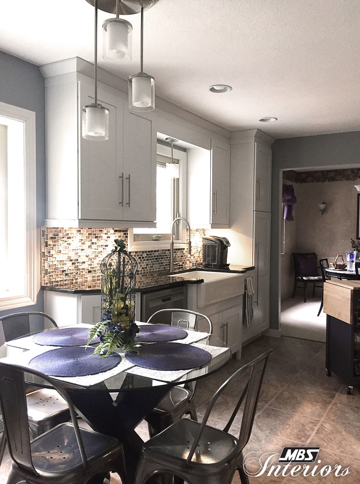 Eat-in kitchen - mid-sized transitional galley ceramic tile and beige floor eat-in kitchen idea with a farmhouse sink, white cabinets, stainless steel appliances, shaker cabinets, granite countertops, blue backsplash, glass sheet backsplash and an island