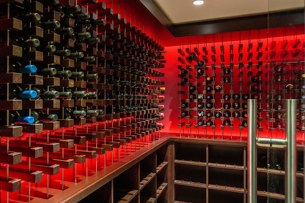 This is an example of a mid-sized contemporary wine cellar in Boston with storage racks.