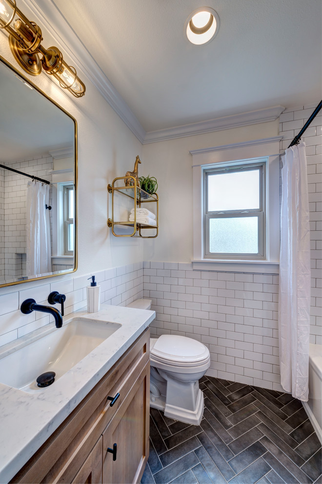 Design ideas for a small country kids bathroom in San Francisco with shaker cabinets, medium wood cabinets, an alcove tub, a shower/bathtub combo, a two-piece toilet, porcelain tile, white walls, porcelain floors, a drop-in sink, engineered quartz benchtops, black floor, a shower curtain, white benchtops and white tile.