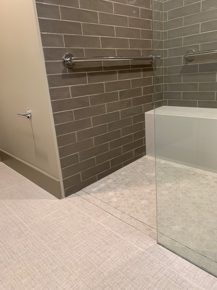 Photo of a mid-sized contemporary master bathroom in Seattle with open cabinets, grey cabinets, a curbless shower, a wall-mount toilet, grey walls, porcelain floors, an integrated sink, glass benchtops, beige floor, an open shower and green benchtops.