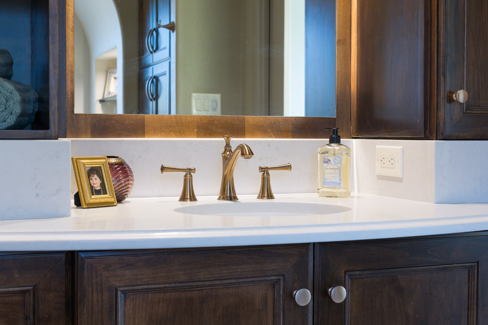 Inspiration for a large transitional master white tile and porcelain tile porcelain tile bathroom remodel in Austin with medium tone wood cabinets, beige walls, an undermount sink, quartz countertops and recessed-panel cabinets
