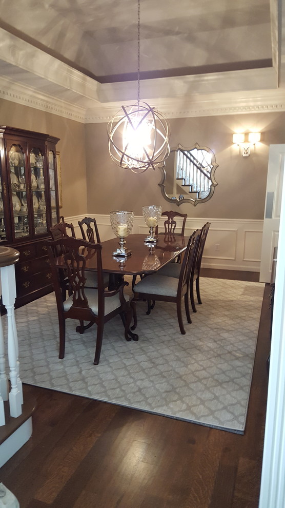 Inspiration for a mid-sized transitional dining room in St Louis with brown walls, medium hardwood floors and brown floor.