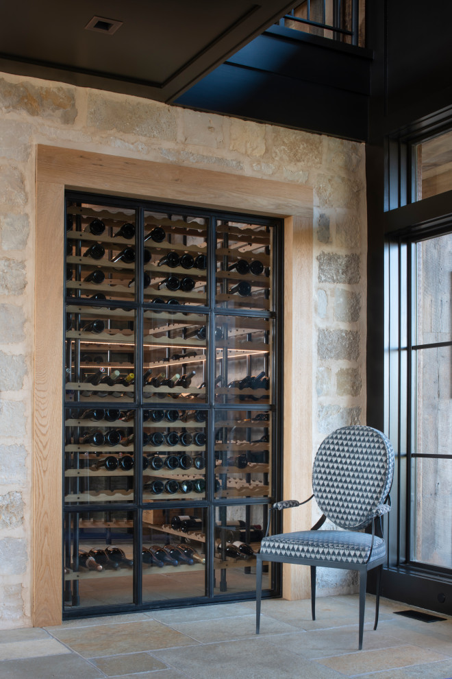 Inspiration for a country wine cellar in Minneapolis with limestone floors.