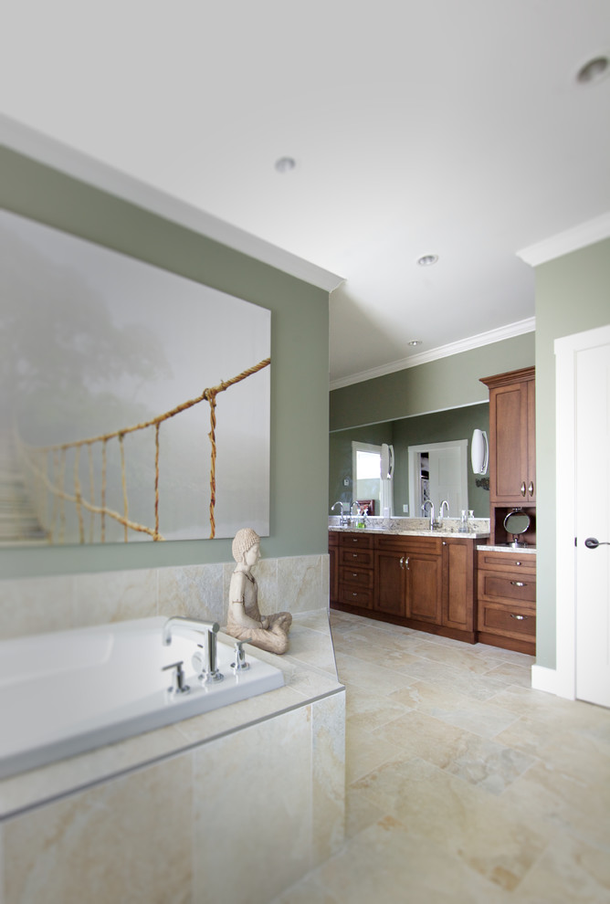 Traditional master bathroom in Vancouver with louvered cabinets, dark wood cabinets, a drop-in tub, a two-piece toilet, beige walls, medium hardwood floors, a vessel sink and granite benchtops.
