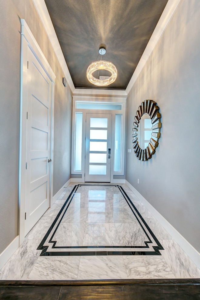 Example of a mid-sized transitional marble floor and white floor entry hall design in Seattle with gray walls and a white front door