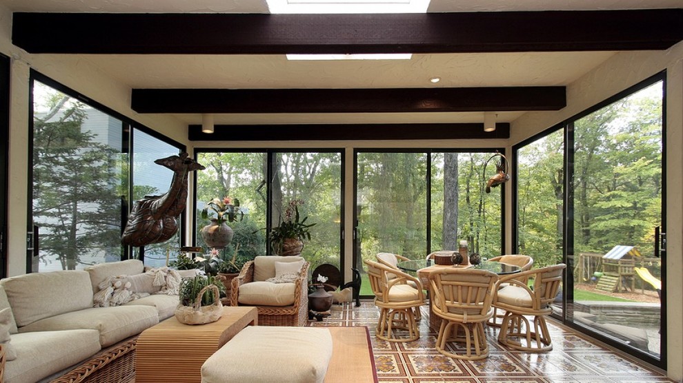 Large scandinavian sunroom in Orlando with ceramic floors, no fireplace, a standard ceiling and brown floor.
