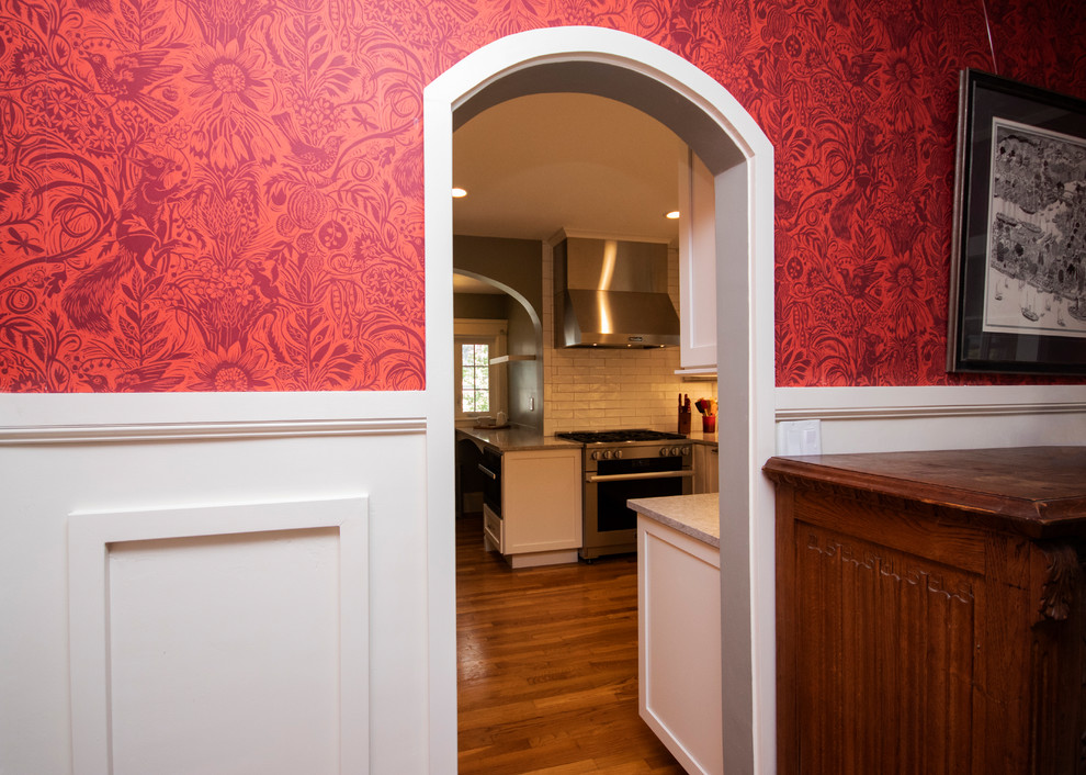 Kitchen pantry - mid-sized transitional l-shaped medium tone wood floor and brown floor kitchen pantry idea in Providence with an undermount sink, recessed-panel cabinets, white cabinets, quartzite countertops, white backsplash, ceramic backsplash, stainless steel appliances, no island and multicolored countertops